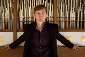 Frederik Magle in front of a pipe organ